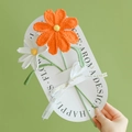 Handmade crochet bouquet with orange lily and white flower on a gift card with ribbon - Cosmos (Orange + White)