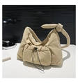 Detail of khaki nylon quilted shoulder bag featuring knot strap and drawstring front pocket - Khaki