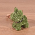 Detailed close-up of a green rhinestone puppy keychain on a wooden surface with bright lighting - Green