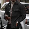 Men's black cargo jacket with chest pockets shown in an outdoor lifestyle setting - Black