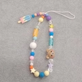 Detailed shot of beaded phone strap with brown bear, ice cream charms and USA beads - Ice Cream Phone Chain