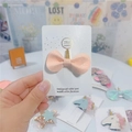 Close-up of a pink glitter bow hair clip on a handmade card with gold accents - Light Yellow Bow with Gold Horn