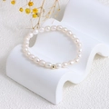Elegant natural freshwater pearl bracelet with a golden bead on a wavy white stand - Creamy Pearl Bracelet with Gold Bead (J-a-027)