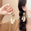Detail of bohemian shell tassel earrings with vintage flower texture on gold finish - 16# Cream White & Gold Tassel Style (Earring Hook)