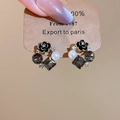 Detail of floral earrings with black petals, pearl accents and grey crystal drops - Silver Pin Black Gold Enamel Flower Style (HE28933)