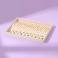 Velvet display tray featuring multiple gold necklaces with blue floral and clover pendants - Beige