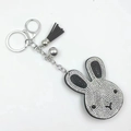 Sparkly bunny head keychain with black and white rhinestones and a black tassel charm - Black with White
