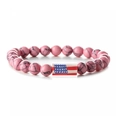 Close-up of pink turquoise beads bracelet with American flag charm on white background - Pink Turquoise Long