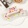 Detail of an ivory rectangular hair claw clip with colorful love hearts and love text - 8.5cm Heart Print - Style C White Base