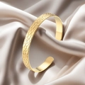 Elegant gold C-shape bangle with honeycomb texture on a champagne silk background - f38 Honeycomb Texture Style / Gold