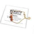 Detail of gold chain bracelet featuring irregular raw carnelian stones and heart charm - Red Agate