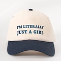Macro view of blue embroidery text on a two-tone cotton twill baseball cap - Beige and Navy / Adjustable