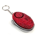 Macro shot of red rhinestone personal alarm with metal keychain and braided lanyard strap - Red