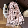 Detail of pink and white plaid scarf with fringe in a stylish autumn still life setting - Pink