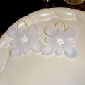 Macro view of white lace floral earrings with golden hooks on ceramic tray - Light Pink Flower Hook