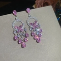 Close-up of pink butterfly zircon earrings with long tassels and sparkling star effects - Silver Earring Post Earrings / Silver-Pink