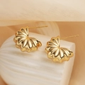 Close-up of gold plated irregular geometric earrings on a white textured base - Irregular Fan Shape (45327) / Gold