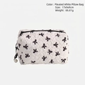 White quilted makeup bag with black bow print and decorative pearl tassel charm - Black White Bow Pillow Bag