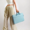 Light blue laptop shoulder bag with top handle and front zipper pocket shown by model - Upgraded Four-pocket Design With Shoulder Straps Can Be Fitted With A Light Blue Rolling Suitcase --- Countdown Special Offer / 13.3 Inch