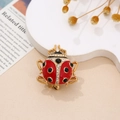 Macro view of creative ladybug brooch with red enamel and sparkling rhinestones - Golden Antenna Style