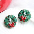 Close-up of Christmas wreath earrings with a red ribbon bow and silver bell detail - Wreath-Silver Bell