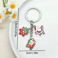 Christmas Santa keychain with snowflake and sleigh charms in red and green enamel finish - Snowflake and Santa on Sleigh (ER830)