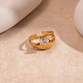 Macro detail of gold open ring with an oval cubic zirconia on a stone surface - Gold Oval Multi Layer
