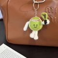 Handmade wool felt tennis player keychain charm on a brown leather luxury bag - Tennis Racket Mascot