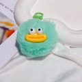 Macro shot of fluffy green pompom keychain with big yellow lips and funny eyes details - Gate Buckle Style / Green
