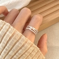 Close-up of a layered silver 925 sterling silver ring worn on a finger with knit sleeve - Multi-layer Cross Silver Style(JZ0623)