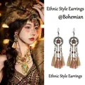 Detail showing vintage bronze floral frame with long light brown silk tassels on earrings - Gold Coffee Ethnic Tassel Style (21# Ear Hook)