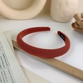 Macro shot of brick red fabric sponge headband with a black hand made label detail - Brown Red