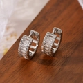 Mini silver hoop earrings with baguette-cut and pavé cubic zirconia on dark wood - Silver