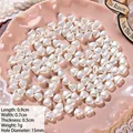 Macro shot of 9mm creamy heart-shaped ABS baroque pearls with 1.5mm holes for DIY jewelry - Heart