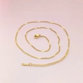 Close-up of gold stainless steel curb chain with lobster clasp and adjustable link extender - Gold Embossed Curb Chain