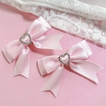 Detail of pink satin bow hair clips with silver heart rhinestones and long ribbons - Pink