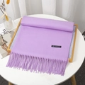 Thick solid lavender cashmere scarf with fringe tassels displayed on a minimal white table - Light Purple
