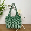 Detail shot of green and white wavy stripe knit tote bag on a white chair - Diamond Pattern Green