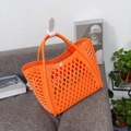 Detail of bright orange hollow mesh jelly basket showing soft silicone texture and dual handles - Small Orange