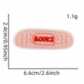 Detail view of a pink bookish adhesive patch showing dimensions 6.6x2.4cm and weight 1.1g - Style 5 (Band-aid Books)