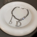 Macro shot of silver letter D bracelet with cubic zirconia on a white ceramic tray - Style 9# Bracelet-Silver Letter D (4899680933118)