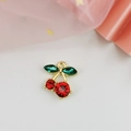 Macro view of red and green cherry zircon pendant with gold-plated alloy base - Double Stone Style