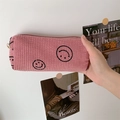 Close-up of pink corduroy cosmetic bag featuring black embroidered smiley face detail - Lotus Pink Smiley (Small)