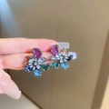 Handheld view of a gunmetal flower earring with multi-colored stones and a white gem - Colorful Flower Rhinestone Style (85#)