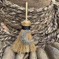 Detail of mini wicca broom with silver crescent moon charm and natural straw texture - Hollow Moon Silver