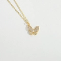 Macro shot of gold butterfly pendant necklace with sparkling crystals on white leather - Single Zirconia Butterfly (XL3283-1)