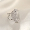 Macro detail of textured silver hammer pattern on wide oval stainless steel ring surface - Round / Silver