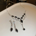 Detailed view of silver necklace and earring set with black marquise stones on a plate - 2# Set-Black