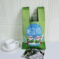 Green knitted tote bag with cute cartoon dumplings and blue circular pattern detail - Green Zongzi