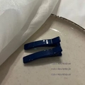 Detail of two dark blue jelly duckbill hair clips on a white ceramic plate background - Square Duckbill Clip / 1 Piece / Navy Blue